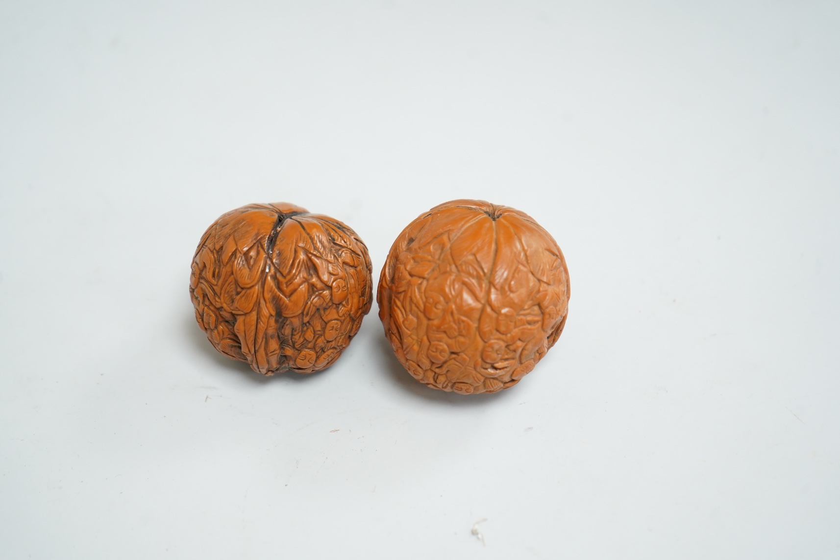 Two Chinese carved walnuts, approximately 4cm in diameter